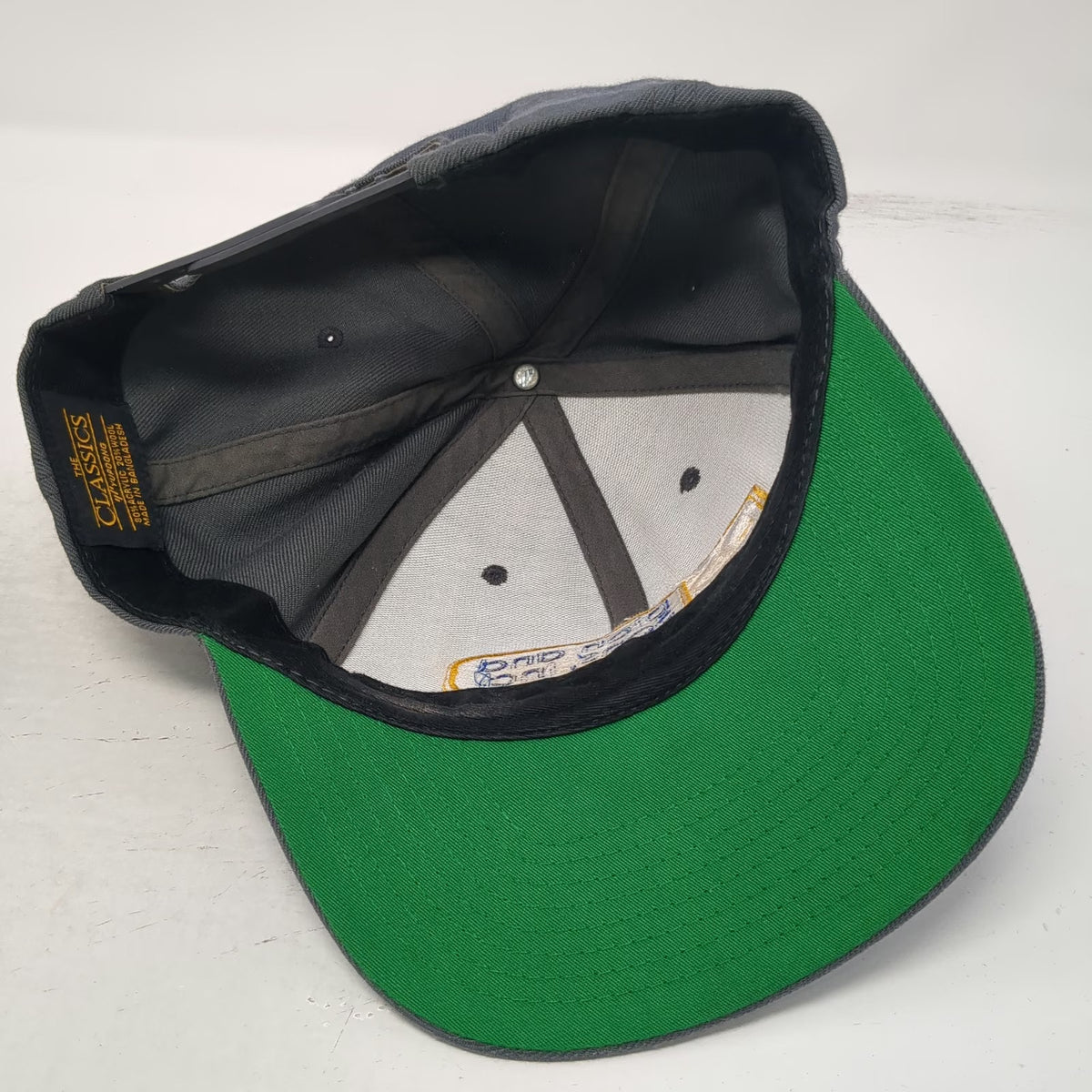 Yupoong Dion and Sons Inc Trucker Hat Gray One Size Snapback Green Under Brim