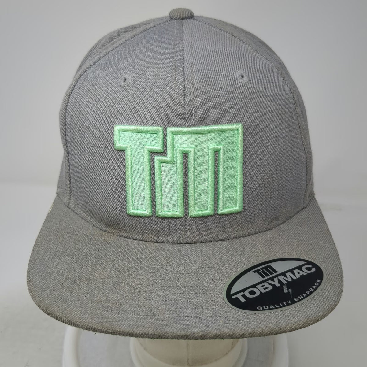 TobyMac Snapback Hat Gray One Size TM Logo I Just Need U Green Underbrim Yupoong