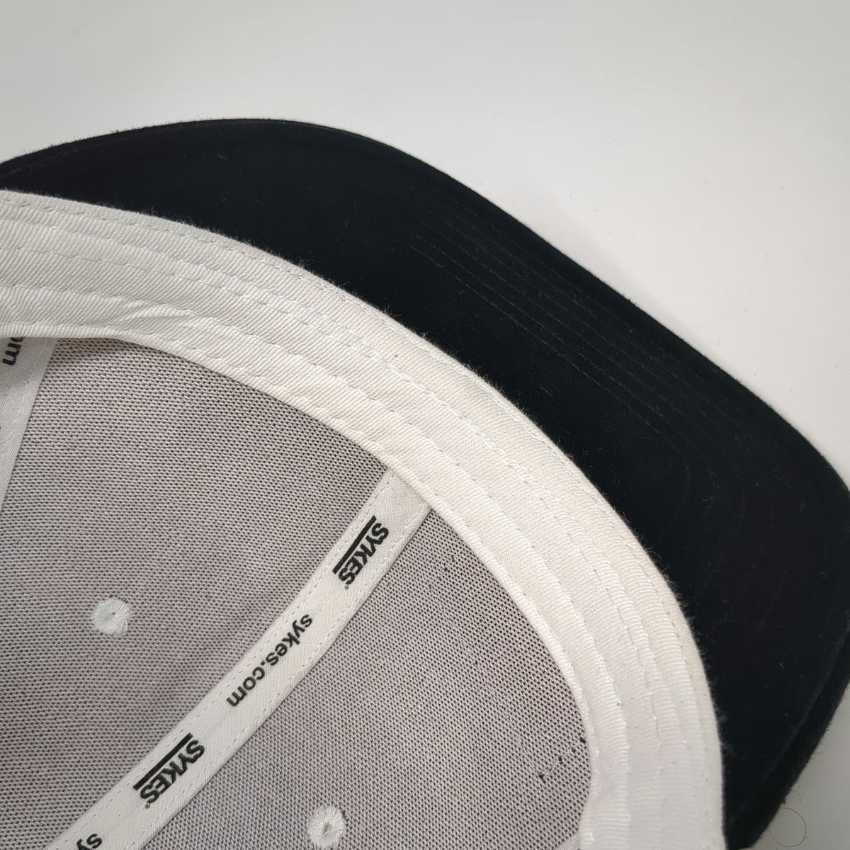 Sykes Snapback Hat White Black One Size Flat Brim Logo Patch Two Tone Cotton