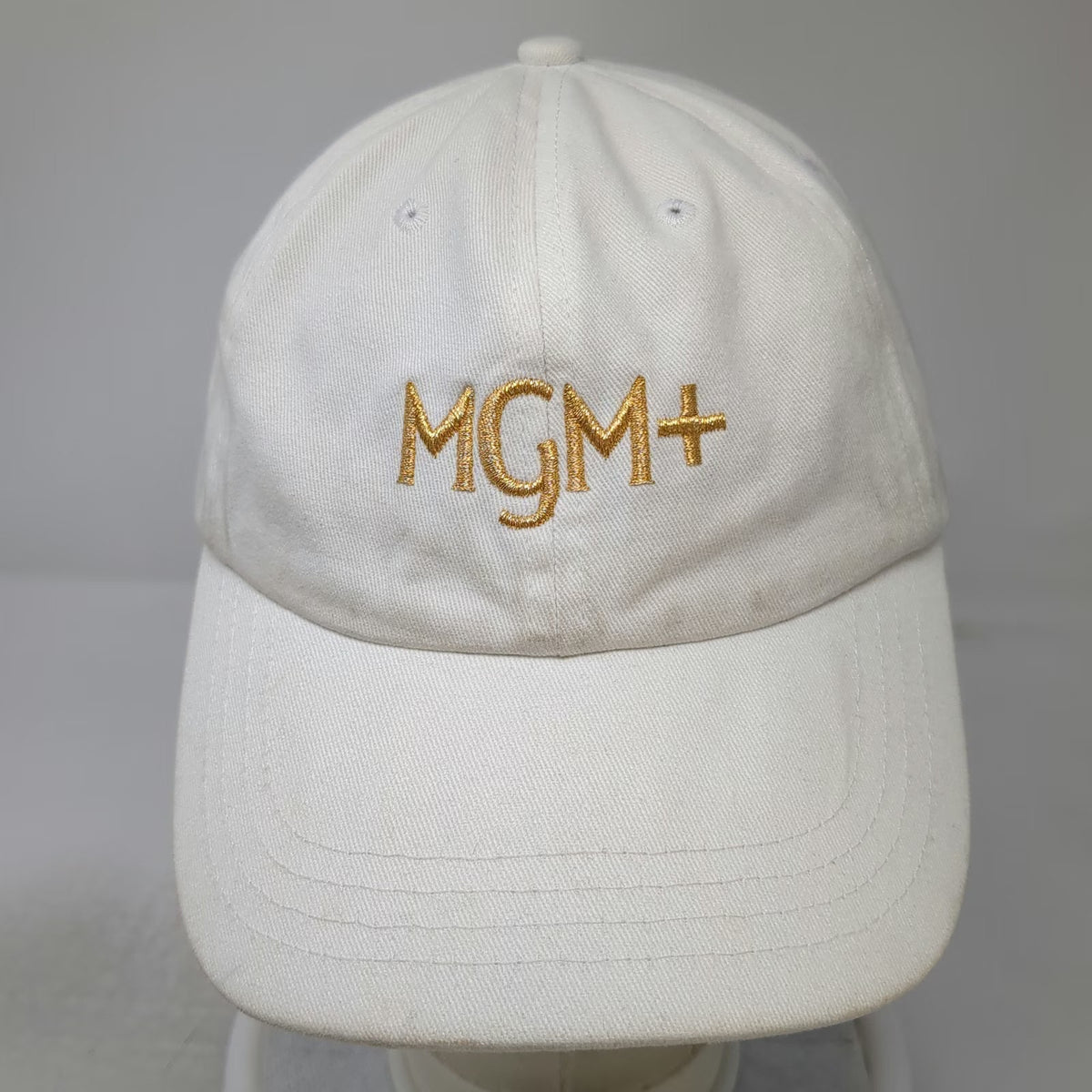 Quake City Caps MGM+ Baseball Cap White One Size Gold Embroidery Slideback Hat