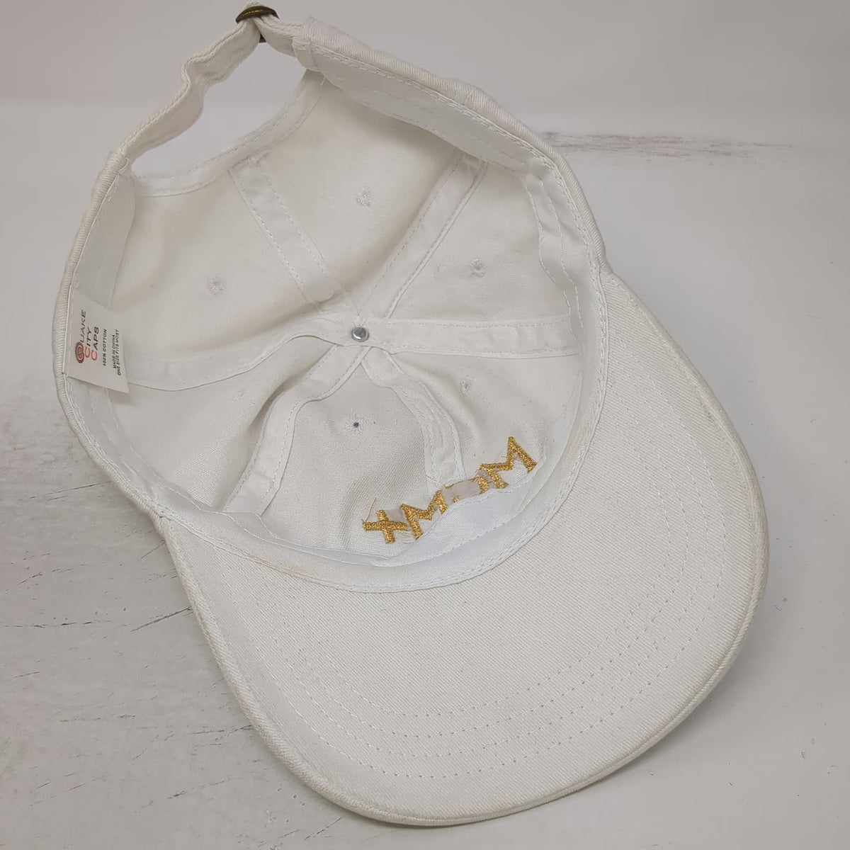 Quake City Caps MGM+ Baseball Cap White One Size Gold Embroidery Slideback Hat
